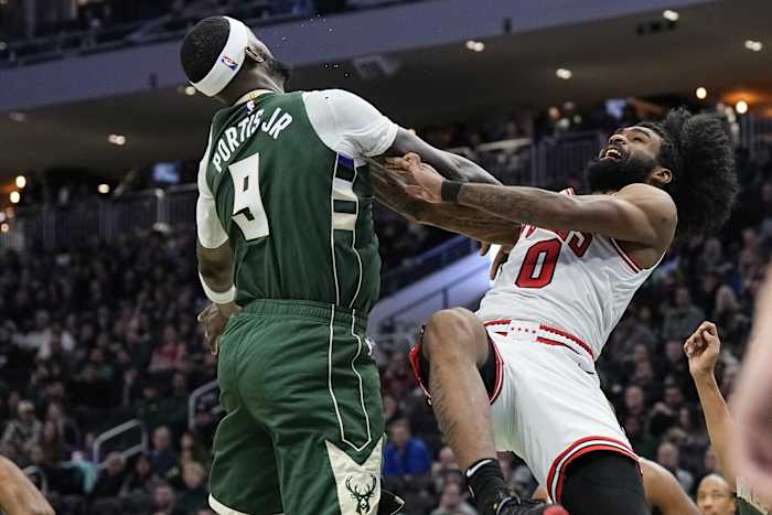 Chicago Bulls guard Coby White (0) is fouled by Milwaukee Bucks forward Bobby Portis (9)